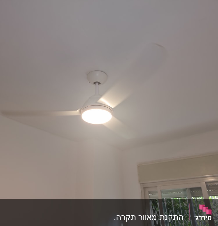מאוורר תקרה עם תאורה דולקת בחדר